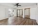 Bright bedroom with wood-look floors, ceiling fan, and closet storage and en-suite bathroom at 5319 E Gelding Dr, Scottsdale, AZ 85254