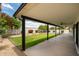 Relax on the covered patio overlooking the lush green lawn and colorful landscaped yard at 5402 E Michelle Dr, Scottsdale, AZ 85254