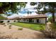 A well-maintained lawn with a brick patio offers a serene outdoor living space at 5402 E Michelle Dr, Scottsdale, AZ 85254