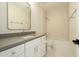 Bathroom featuring white cabinets, modern fixtures, shower and tub at 5402 E Michelle Dr, Scottsdale, AZ 85254