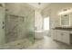 Modern bathroom features a glass-enclosed shower, soaking tub, and stylish vanity with modern fixtures at 5402 E Michelle Dr, Scottsdale, AZ 85254