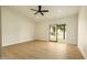 Spacious bedroom with light wood floors, ceiling fan, and sliding door access to outdoor living space at 5402 E Michelle Dr, Scottsdale, AZ 85254