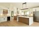 Bright kitchen features white cabinets, stainless steel appliances, and large center island perfect for entertaining at 5402 E Michelle Dr, Scottsdale, AZ 85254