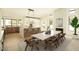 Open concept kitchen with bar seating, modern light fixture, fireplace and adjacent dining area at 5402 E Michelle Dr, Scottsdale, AZ 85254