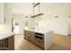 Modern kitchen features an island, stylish cabinetry, stone countertops and stainless appliances at 5402 E Michelle Dr, Scottsdale, AZ 85254