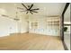 Spacious living room with wood floors, built-in storage, and a modern chandelier at 5402 E Michelle Dr, Scottsdale, AZ 85254