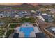 Aerial shot of a community pool and landscaped common area surrounded by homes at sunset at 5901 E Sierra Morena St, Mesa, AZ 85215