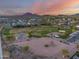 Beautiful aerial view of a neighborhood park, playground, and mountain views at sunset at 5901 E Sierra Morena St, Mesa, AZ 85215