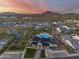 Aerial view of community pool, amenities, and surrounding homes with mountain backdrop at 5901 E Sierra Morena St, Mesa, AZ 85215
