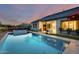 Stunning backyard with a large pool, spa, covered patio, and lush landscaping, perfect for outdoor entertaining at 5901 E Sierra Morena St, Mesa, AZ 85215