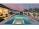 Expansive backyard with a pool, spa, multiple seating areas, and professionally designed landscaping, ideal for entertaining at 5901 E Sierra Morena St, Mesa, AZ 85215