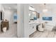 Elegant bathroom with a soaking tub, a vanity, and a chandelier creating a spa-like atmosphere within the primary suite at 5901 E Sierra Morena St, Mesa, AZ 85215