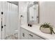 Bright bathroom featuring a decorative mirror, white vanity, and a shower-tub combination at 5901 E Sierra Morena St, Mesa, AZ 85215