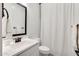 Bright bathroom featuring a framed mirror, white vanity, and a shower-tub combination at 5901 E Sierra Morena St, Mesa, AZ 85215
