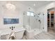 Bright bathroom features soaking tub, walk-in shower with glass enclosure, and chandelier at 5901 E Sierra Morena St, Mesa, AZ 85215