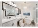 Bright bathroom features dual vanities, chandelier, soaking tub, and walk-in shower at 5901 E Sierra Morena St, Mesa, AZ 85215