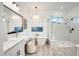 Bright and modern bathroom featuring a glass-enclosed shower, a soaking tub, and vanity with dual sinks at 5901 E Sierra Morena St, Mesa, AZ 85215