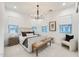 Bright bedroom with a chandelier, accent chair, large windows, and a plush area rug at 5901 E Sierra Morena St, Mesa, AZ 85215