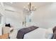 Bright bedroom with a chandelier, accent chair, large windows, and a plush area rug at 5901 E Sierra Morena St, Mesa, AZ 85215