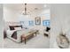 Bright bedroom with a chandelier, accent chair, large windows, and a plush area rug at 5901 E Sierra Morena St, Mesa, AZ 85215