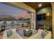 Relaxing covered patio featuring comfortable seating, an outdoor fireplace, and a beautiful view of the pool and spa at 5901 E Sierra Morena St, Mesa, AZ 85215