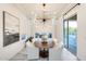Bright dining room featuring modern chandelier, with seating for six, and large glass sliding doors at 5901 E Sierra Morena St, Mesa, AZ 85215