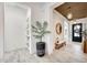 Inviting entryway featuring modern finishes, wood-look tile flooring, and a decorative plant, creating a welcoming ambiance at 5901 E Sierra Morena St, Mesa, AZ 85215