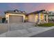 Charming single-Gathering home featuring stucco siding, gray accents, three-car garage, and manicured front yard at 5901 E Sierra Morena St, Mesa, AZ 85215