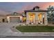 Charming single-Gathering home featuring stucco siding, gray accents, three-car garage, and manicured front yard at 5901 E Sierra Morena St, Mesa, AZ 85215