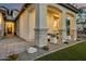 Close-up of front porch with stone columns, and manicured lawn and landscaping at 5901 E Sierra Morena St, Mesa, AZ 85215