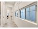 Hallway with white walls and modern window shades with views through house at 5901 E Sierra Morena St, Mesa, AZ 85215