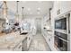 Bright kitchen featuring stainless steel appliances, granite countertops, and a spacious center island with pendant lighting at 5901 E Sierra Morena St, Mesa, AZ 85215