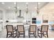 Bright kitchen featuring a center island with seating, stainless steel appliances, and modern pendant lights at 5901 E Sierra Morena St, Mesa, AZ 85215