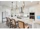 Bright modern kitchen boasts white cabinets, granite counters, and barstool seating at 5901 E Sierra Morena St, Mesa, AZ 85215