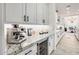 Bright kitchen featuring granite countertops, white cabinets with black hardware, and stainless steel appliances at 5901 E Sierra Morena St, Mesa, AZ 85215