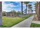 Community park featuring a playground and picnic area surrounded by mature trees at 5901 E Sierra Morena St, Mesa, AZ 85215