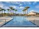 Large community pool with clear blue water, tile trim and desert landscaping at 5901 E Sierra Morena St, Mesa, AZ 85215