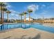 Community swimming pool surrounded by palm trees and ample seating at 5901 E Sierra Morena St, Mesa, AZ 85215