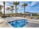 Inviting hot tub with poolside seating, landscaping and palm trees at 5901 E Sierra Morena St, Mesa, AZ 85215