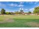 View of the community volleyball court with green grass and blue skies on a sunny day at 5901 E Sierra Morena St, Mesa, AZ 85215