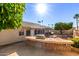 Backyard view features built-in barbecue area, mature trees, a lush garden, and outdoor dining space at 7002 E Exmoor Dr, Mesa, AZ 85208