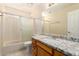 Well-lit bathroom includes a shower/bathtub combination and granite countertop vanity at 7002 E Exmoor Dr, Mesa, AZ 85208