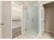Bathroom featuring a shower with glass door and walk-in closet for optimal storage space at 7002 E Exmoor Dr, Mesa, AZ 85208