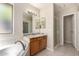 Bright bathroom featuring a soaking tub, wooden vanity and a walk-in shower at 7002 E Exmoor Dr, Mesa, AZ 85208