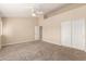 Spacious bedroom featuring carpet, neutral walls, ceiling fan, and double door closet at 7002 E Exmoor Dr, Mesa, AZ 85208