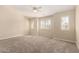 Carpeted bedroom featuring neutral walls, ceiling fan, and windows providing natural light at 7002 E Exmoor Dr, Mesa, AZ 85208
