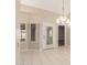 Bright dining room with tile floors, a modern chandelier, and shutters on the windows at 7002 E Exmoor Dr, Mesa, AZ 85208