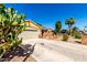 Single level home showcasing mature landscaping, rock details and a spacious driveway at 7002 E Exmoor Dr, Mesa, AZ 85208