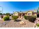 Inviting front exterior featuring manicured landscaping, stone accents, and a well-maintained lawn at 7002 E Exmoor Dr, Mesa, AZ 85208