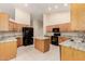 Spacious kitchen with stainless steel appliances, granite countertops, and tile flooring at 7002 E Exmoor Dr, Mesa, AZ 85208